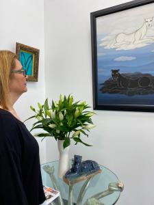 Woman regarding art in a gallery