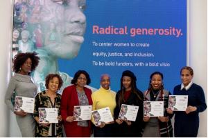 (Left to Right): Honorees Ngozi Okaro, Dr. Danielle R. Moss Cox, Marjorie Cadogan, Soffiyah Elijah, Dominic-Madori Davis, Rashidah Siddiqui, and Rosemonde Pierre-Louis in front of The New York Women’s Foundation’s Black History Month Display in World Tra