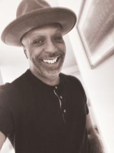 Black and white portrait of artist Sidney Woodruff with a big smile