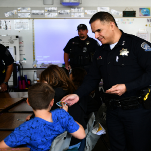 Modesto PD police officers interacting with students in a classroom.
