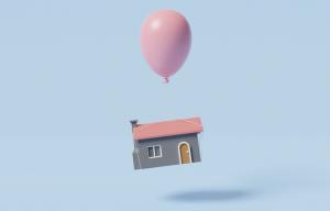 House flying with air balloon, rising of real estate price due to inflation, overvalued property or asset bubble concept