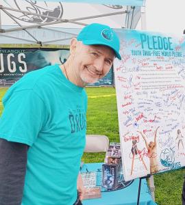 Another photo of Nathan at the Drug-Free World pledge board