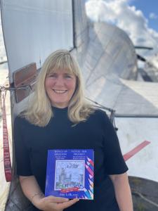 Bibi LeBlanc with book 'Wings of Freedom' in front of a DC3