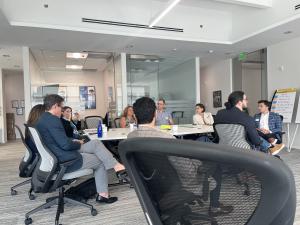 Event attendees in a lively discussion on the practical applications of AI in business during the 'Empowering your Business with AI Capabilities' workshop