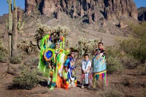 The Hammill Family poses in the desert in full Native American regalia