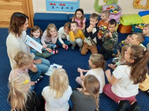 Teacher Tetiana Stadnytska (left) shares a moment with children enrolled in the Education Above All (EAA) Foundation's Ukraine Emergency Education Program, fostering learning and stability for Ukrainian refugee children.