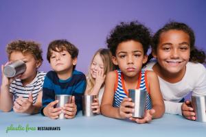 Five adorable kids drinking milk from reusable stainless steel cups.