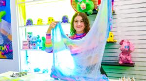 Ameerah holding Cloud slime at the DIY slime bar at the Slimeatory store