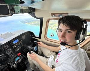 16-year-old Jett Justin flies an airplane over Grand Bahama during an Oatmeal Airlift to combat food insecurity on the island