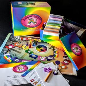 Photo of Rainbow Quest! board game showing the board, prompt cards, and meeples.  