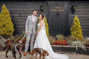 Happy couple and their dogs at their wedding