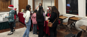 Staff of Tulare County Museum catering to a group of children inside the museum.
