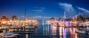Nights lights at a lake with boats.
