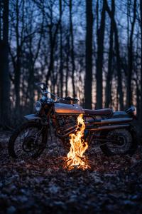 Janus' Gryffin 450 Prototype sitting by a campfire in the woods.