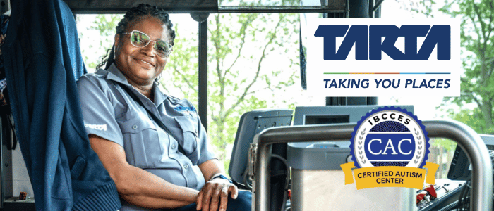 An African-American driver, photographed inside a bus.