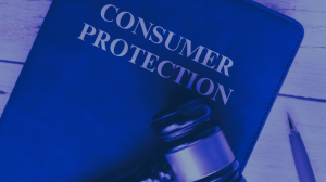  A gavel resting on a 'Consumer Protection' booklet with a pen alongside, representing the enforcement of consumer rights.