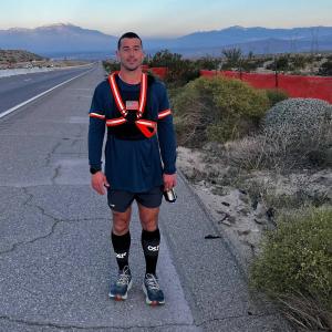 Andrew Linder stands in his weighted vest along his desert running route