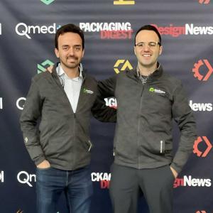Photo of the Reshape Founders, Carlos Vanegas (left) & Juan Aparicio (right). They are posing in front of a banner
