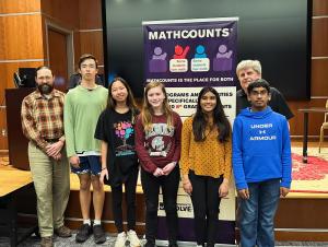 Top four Mathletes (3 girls and one boy) pose with coaches and supporters.