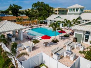 ShoreView Apartments showcasing amenities such as the resort-style pool with sundeck, outdoor kitchen and grilling area, fire pit, clubroom with lounge, and waterfront views