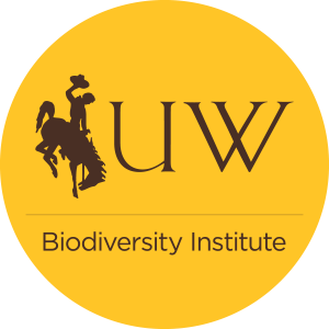 University of Wyoming Biodiversity Institute Round Logo - Silhouette of a cowboy riding a bucking horse with "UW" and "Biodiversity Institute" in brown text on yellow background