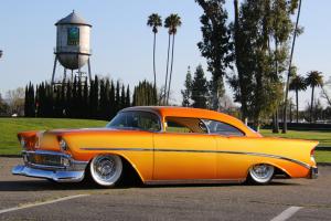 A customized, glowing gold 1956 Chevy.