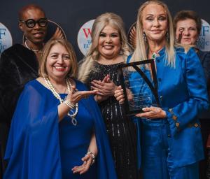 Barbara Winston accepts the WEF Award as Woman of the Decade from Maria Fernanda Reyes. Pictured with Winston from left are Caroline Sack Kendem and Carmen Velasquez, NY Supreme Court Justice, on the stage of the Harvard Club in New York.
