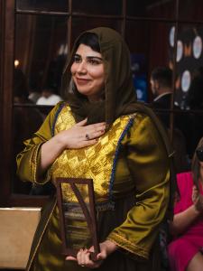 Pashtana Durrani holds the WEF Award she received for advancing gender equity and equality.