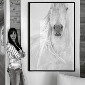 Photographer Maria Marriott in gallery with her artwork, "Tango"