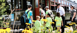 Children lining up to ride a bus.