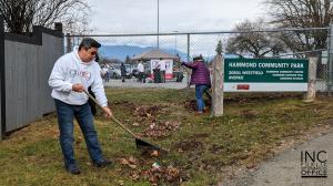 INCGiving volunteer raking dried leaves and cleaning up garbage at Hammond Community Park