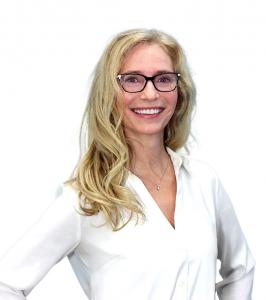 New Bathing Brands President Tina Adams smiling in front of a white background.