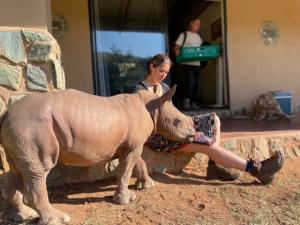 Director Mara Eibl-Eibesfeldt and baby rhino Daisy on the set of Thabo and the Rhino Case