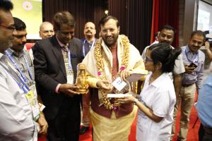 Minister of Human Resource Development in India receiving a memento celebrating the launch of MageQuill in India