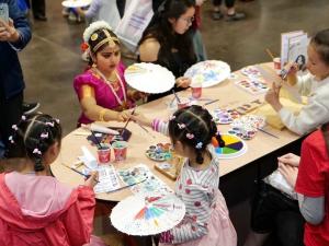 Kids enjoying paper umbrella painting at the Taiwan Pavilion