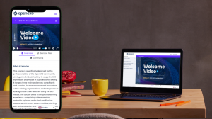 A smartphone and a laptop on a wooden desk, showcasing the 'Welcome Video' of the 'ExO Pro Foundations' course on OpenExO, accompanied by office supplies, a pomegranate, and a yellow cup.