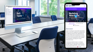 A professional conference room setup with an iMac and a smartphone on a sleek white table, both showing the OpenExO platform's 'Building New ExOs' lesson from the 'ExO Pro Foundations' course.