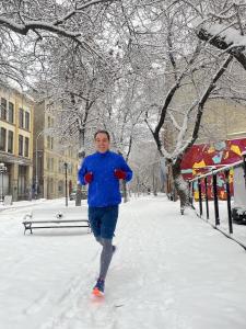 Rob running in the snow in downtown winnipeg