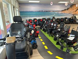 Photo of the Mobility City of San Diego showroom with electric wheelchairs, scooters, and  mobility equipment products, a test track for customers to experience product features, for rental and sale.