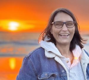 Headshot of Delicia Niami at beach in Santa Cruz at sunset