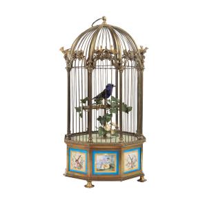 Circa 1885 French Bontems caged singing bird automaton in a bronze cage, 18 ½ inches tall, with applied scenic Sevres plaques surrounding the base panels (est. CA$9,000-$12,000).