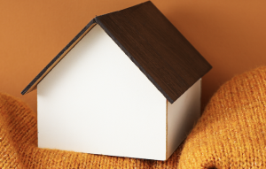 Model of a home resting on a scarf.
