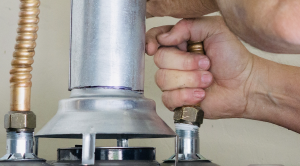 Man repairing a water heater.