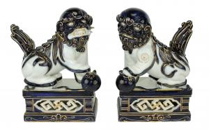 Pair of circa 1875 Royal Worcester Aesthetic Movement foo dogs, each decorated in blue and white with 22-ct. gilding, perched on a faux Japanese style hardwood stand (est. $800-$1,200).