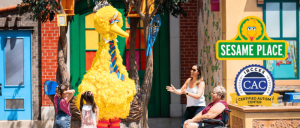 Big Bird interacting with a woman, two children, and an old woman in a wheelchair at Sesame Place Parks.