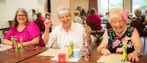 Three elderly women doing some art activities at The Joslyn Center.