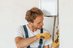 Man repairing a water heater.