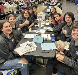 students sitting at a table waiting to start math problems