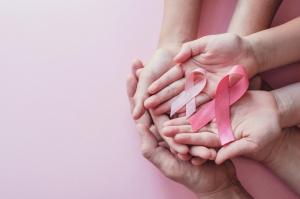 Hands holding cancer ribbons.
