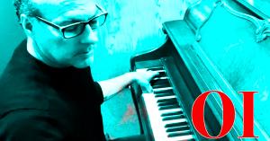 Michael Faeth sitting at a piano with the initials OI in the lower right hand corner.